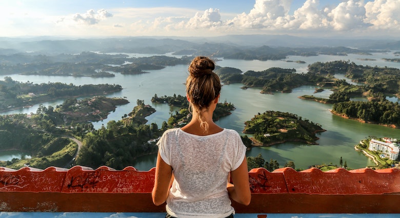 A girl looks over Guatape and the expansive lake system.