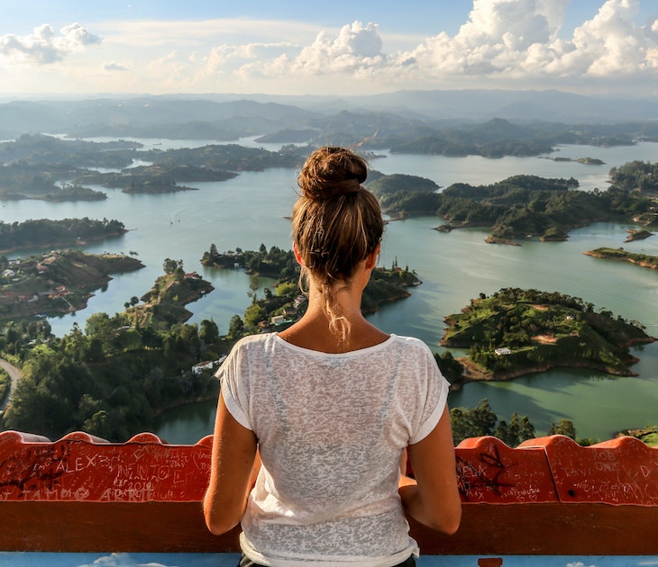 A girl looks over Guatape and the expansive lake system.