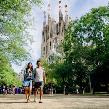 Walking through Barcelona park near Sagrada Familia.